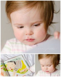 little baby girl reading a book