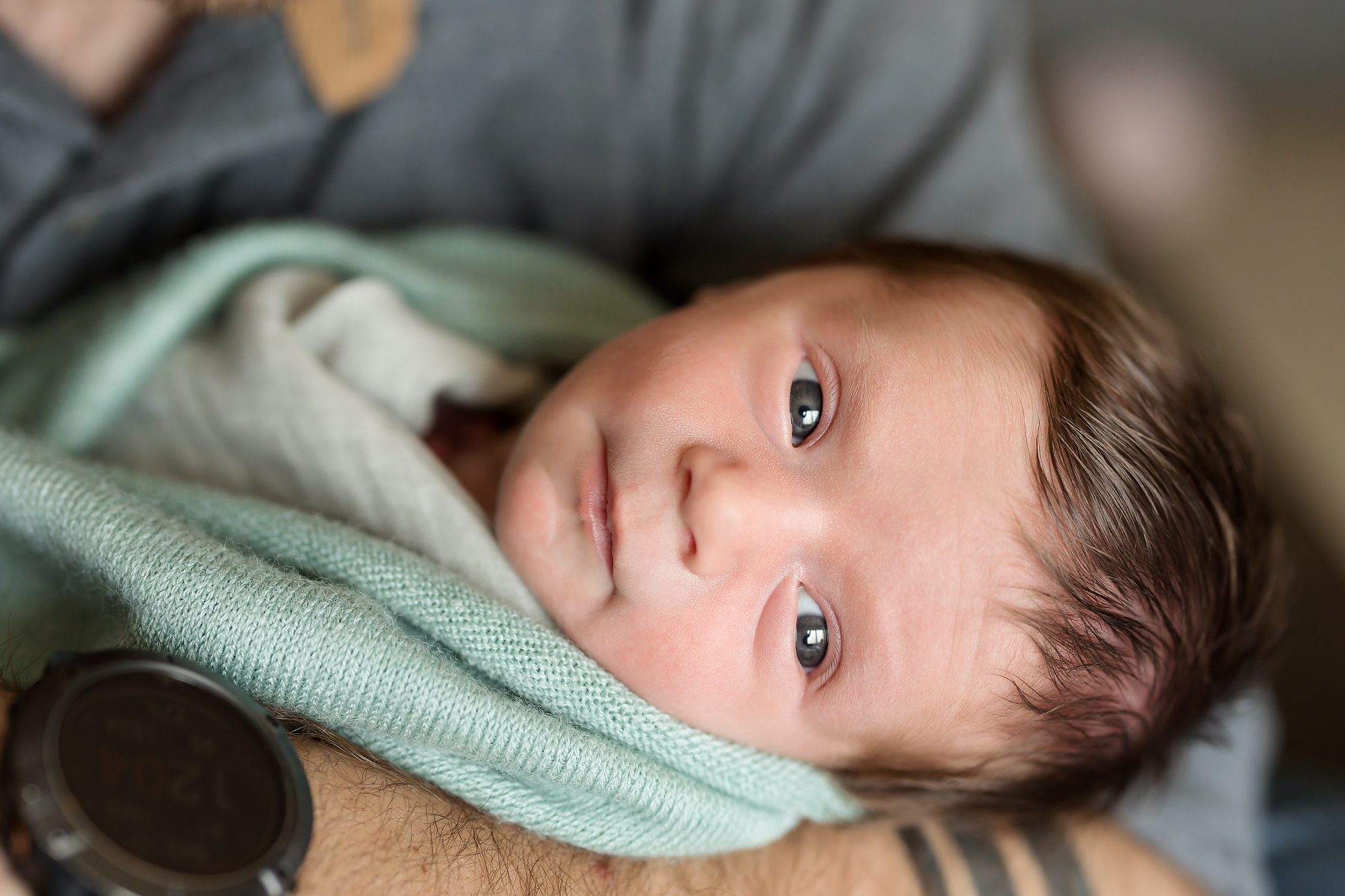 photo of newborn baby boy being held by his dad for a Colorado Springs newborn photography session