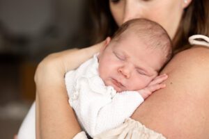 photo of mom and newborn baby girl at kindle studio in Colorado springs taken by Anne at Anne Jensen photography